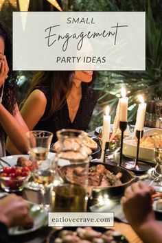 a group of people sitting around a dinner table with food and candles in the background