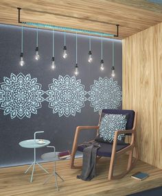 a chair and table in front of a wall with lights hanging from it's sides