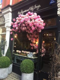 a flower shop with pink flowers on display