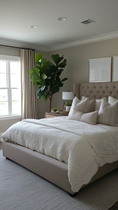 a large bed sitting in a bedroom next to a window with curtains on both sides