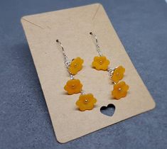 ORANGE OPEN FLOWER EARRINGS * Handmade orange flower earrings * Frosted orange lucite acrylic flowers measuring 11mm x 4.5mm * Individual wire wrapped * Silver plated components (chain, bead caps, wire) * Also available in other colours, please see my shop * Choice of ear wires * Rubber earring stops * Optional sterling silver ear wires are high quality solid 925 sterling silver hallmarked and a sturdy 0.8mm gauge TIME IT TAKES TO MAKE YOUR ITEM * Every single item is handmade to order with the Orange Flower-shaped Adjustable Earrings, Nickel-free Orange Flower Earrings, Orange Flower-shaped Earrings For Gift, Orange Dangle Flower Earrings Gift, Orange Dangle Flower Earrings For Gift, Orange Dangle Flower Earrings With Ear Wire, Orange Adjustable Dangle Flower Earrings, Yellow Earrings With 3d Flowers As A Gift, Orange Drop Earrings For Gift