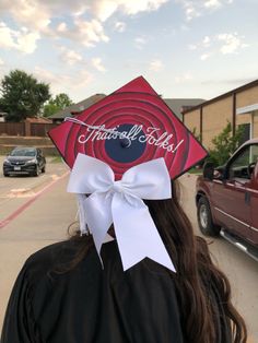 a woman wearing a graduation cap with the words thank all teacher on it's side