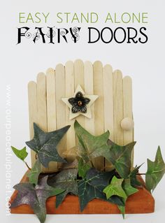 an easy stand alone fairy door made out of popsicle sticks with ivys on it