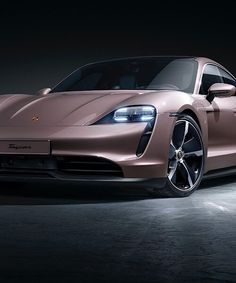 a pink porsche sports car parked in a dark spot with its hood up and lights on