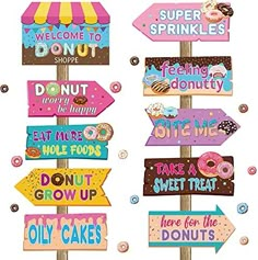 wooden signs with donuts, donuts and donut shops on them are painted in different colors