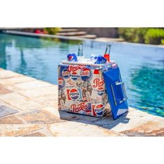 a cooler sitting next to a swimming pool