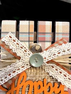 a close up of a piece of paper with the words happy on it and an orange ribbon