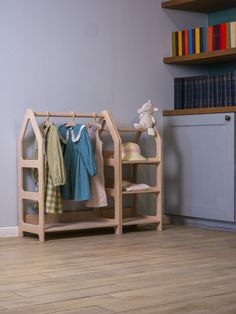 a wooden shelf with clothes hanging on it