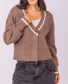 This classic chic Amory Puff Sleeve Wrapped Sweater Top offers sophisticated style with timeless allure. Crafted from a luxuriously soft blend of 60% Acrylic, 30% Polyester, and 10% Nylon, this chestnut-colored top features a flattering V-neckline, long sleeves, and a drop shoulder for a modern feel. Its ribbed hem and front button closure complete the look perfectly. Indulge in the luxury of this chic top.