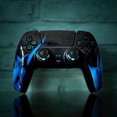 a close up of a controller on a table with a brick wall in the background