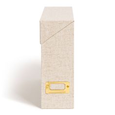 a white box with a gold handle on the front and bottom, sitting against a white background