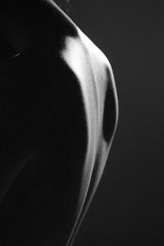 black and white photograph of the back of a man's torso with no shirt on