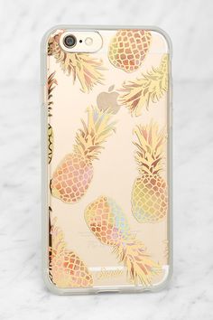 an iphone case with pineapples on the front and back, sitting on a marble surface