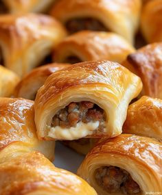 several pastries with meat and cheese in them