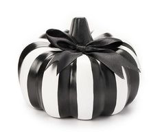 a black and white striped pumpkin with a bow