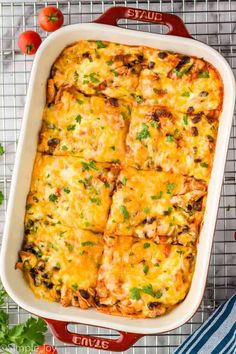 an enchilada casserole in a red dish on a cooling rack