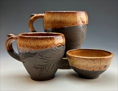 three coffee mugs sitting next to each other