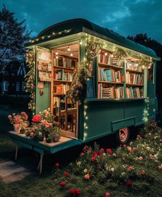 an old truck converted into a library with flowers and bookshelves on the side