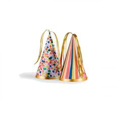 two party hats with ribbons and confetti on them