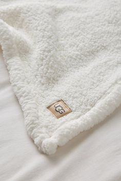 Enjoy a luxurious getaway every day with this super plush sleep set from UGG. This giftable set features a cozy fleece throw blanket, a fleece eye mask and a fleece tote bag to carry your essentials wherever you go. Features UGG fleece throw blanket sleep set UGG plush fleece throw blanket Textural fleece eye mask Carry all your cozy essentials in the included fleece tote bag Perfect for gifting Content + Care Includes throw blanket, eye mask & tote bag Fleece Throw blanket is machine washable S Ugg Throw Blanket, Urban Outfitters Blanket, Ugg Blanket, Blanket Dimensions, Cozy Essentials, Cozy Boots, Men's Shoes Accessories, Luxury Getaway, Sleep Set