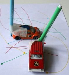 a red toy car with a green pencil in it and the words les voitures feutres