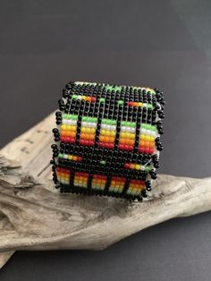 "Native America Indian Jewelry. This is a stunning fully beaded Navajo bracelet. Made by hand from a Navajo family of women that do spectacular beadwork in a wide variety of items. This beautiful bracelet is 1.50\"x 6\" end to end with a 1.25\" opening, white leather over playable metal. This is a gorgeous colorful bracelet that will look fabulous on everyone! Please look closely at photos. Welcome to NorthWestTradingCo" Handmade Southwestern Black Beaded Bracelets, Handmade Black Southwestern Beaded Bracelets, Southwestern Black Beaded Bracelet With Colorful Beads, Southwestern Black Beaded Bracelets, Southwestern Style Black Beaded Bracelet With Colorful Beads, Black Beaded Southwestern Bracelets, Southwestern Style Black Beaded Bracelets, Southwestern Style Multicolor Beaded Cuff Bracelet, Multicolor Southwestern Beaded Bracelet