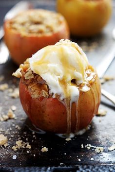 an apple with some ice cream on it and two other apples in the back ground