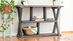 a wooden shelf with books and plants on it