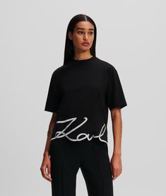 The elegant KARL Signature logo, playfully positioned at the hemline, transforms this casual wardrobe staple. Made from organic cotton, this classic crew-neck T-shirt features a KARL Signature embroidered hem at the front and Essential KARL logo at the back neck. Embroidered Hem, Heel Accessories, Timeless Dress, Blouse Jeans, Rock Chic, Sleepwear & Loungewear, T Shirt For Women, Signature Logo, Casual Wardrobe