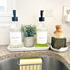 a sink with soap, scrubber and brush in it