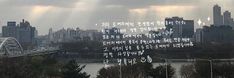 an image of the city skyline from across the river with sunbeams in the sky