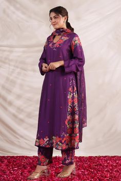 Purple silk kurta with multi color placement floral print, sequin, bead and French knot thread embroidered highlights. Paired with printed palazzo and dupatta.
Components: 3
Pattern: Printed and Hand Embroidered
Type Of Work: Floral Print, Bead, Sequin and French Knot Thread Work
Neckline: V Neck
Sleeve Type: Full Sleeves
Fabric: Silk, Dupatta: Mulberry Silk
Color: Purple
Other Details: 
Bead tasselled dupatta edges
Side slits
Embroidered highlights
Model height: 5ft inches, wearing size S
Occas Purple Unstitched Suit With Cutdana, Semi-stitched Chanderi Sets With Meenakari, Semi-stitched Meenakari Chanderi Sets, Traditional Purple Unstitched Suit With Sheer Dupatta, Semi-stitched Purple Meenakari Dupatta, Chanderi Salwar Kameez With Meenakari Straight Kurta, Chanderi Sets With Meenakari, Anarkali Unstitched Suit With Meenakari For Designer Wear, Traditional Purple Palazzo Set With Sheer Dupatta