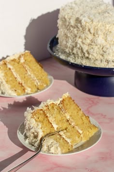 two plates with slices of cake on them and one has a fork stuck in it