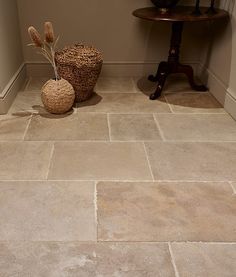 two baskets sit on the floor next to each other in a room with beige walls