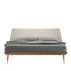 an upholstered daybed with two pillows on the top and bottom, sitting against a white background