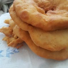 three fried donuts stacked on top of each other