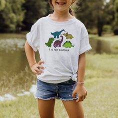 The perfect shirt for the dinosaur loving kid! T-Rex, stegosaurus, triceratops and more!  D is for Dinosaur kids/toddler/baby tshirt, dinosaur loving toddler, gifts for kids, toddler tshirt, dinosaur birthday party shirt ----WASHING INSTRUCTIONS----- - Please turn the tee inside out before washing - Cold machine wash in gentle cycle - Do not bleach - Do not dry clean - Do not iron over the HTV Fun Short Sleeve Dinosaur Print T-shirt, Playful Dinosaur Print Crew Neck T-shirt, D Is For Dinosaur, Dinosaur Birthday Party, Birthday Party Shirt, Dinosaur Kids, Dinosaur Birthday, Toddler Gifts, Party Shirts