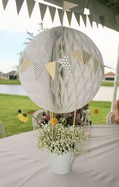 a vase filled with flowers sitting on top of a table next to a white table cloth