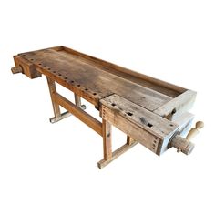 an old wooden bench with holes in the middle and wheels on it's sides