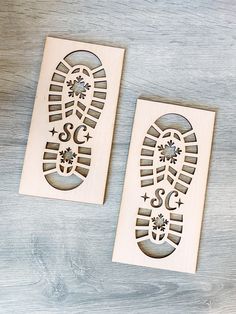 two wooden stamps with footprints and stars on them