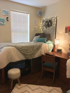 a bed room with a neatly made bed and a desk