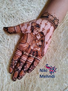 the henna is decorated with an intricate design on it's palm and hand