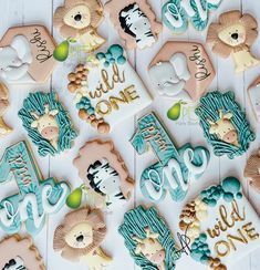 some cookies that are decorated to look like animals and the words wild one on them