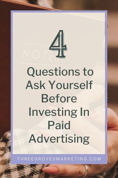 a person holding a book with the text 4 questions to ask yourself before investing in paid advertising