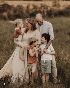 a family standing in tall grass together