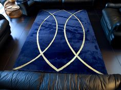 a blue rug with gold lines on it in the middle of a living room area