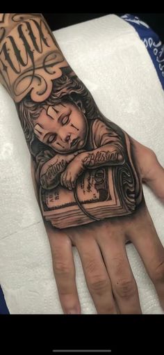 a person's hand with a tattoo on it