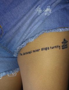 a woman's thigh with the words, the carousel never stop turning written on it