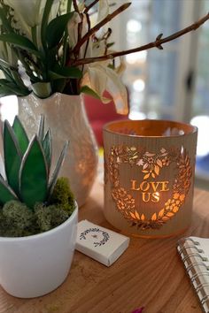 A wood and glass lantern carved with hearts and leaves saying love us lit with a candle. Perfect decor for weddings, and engagements Lantern Photography, Artificial Candles, Romantic Candlelight, Art Couple, Candle Cover