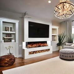 a living room with a couch, chair and fireplace in it's centerpiece